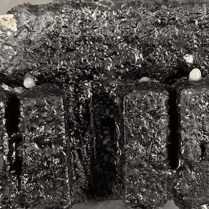 A close up of a charred glue gun before parts restoration. 