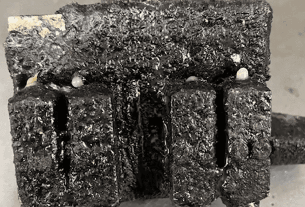 A close up of a charred glue gun before parts restoration. 