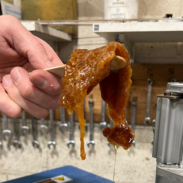 Adhesive from a hot glue machine which is starting to degrade.