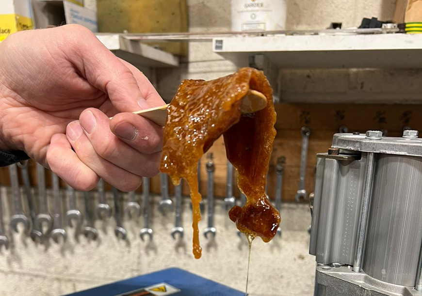 Adhesive from a hot glue machine which is starting to degrade.